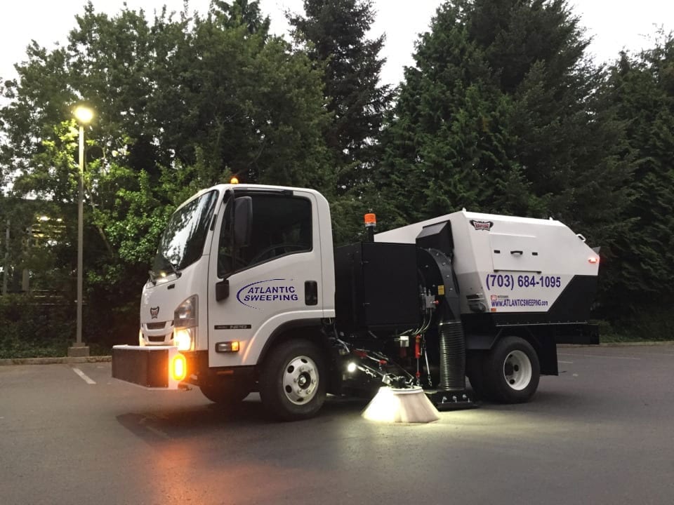 Atlantic Sweeping sweeper truck in action at twilight