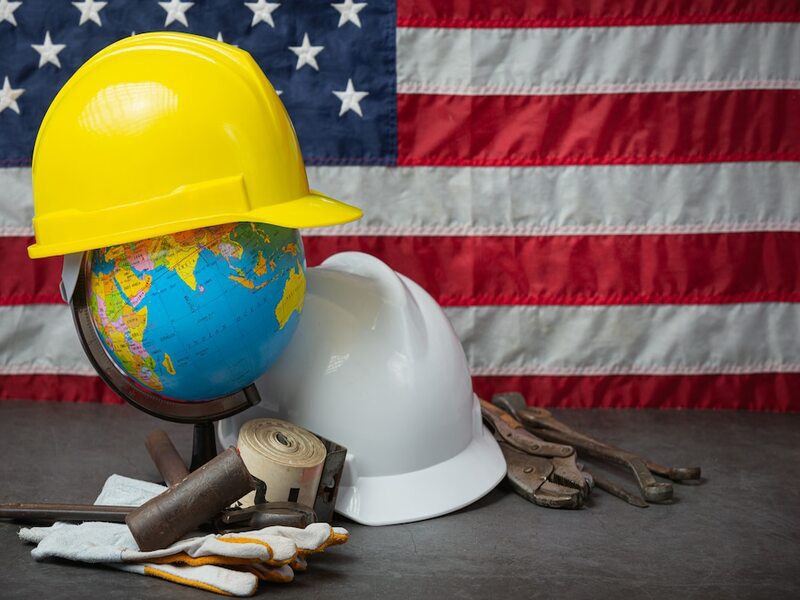 American flag, tools, work gloves, hardhats to honor Labor Day