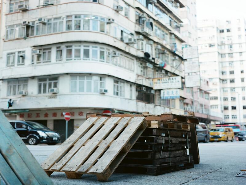 stack of unsightly empty pallets on a city street