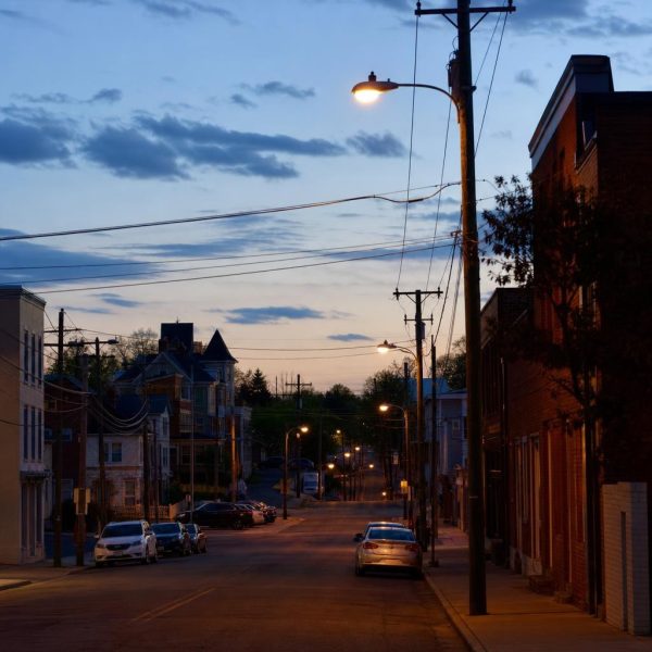 Manassas street with mixed commercial and residential buildings near the historic railroad-centered city core.